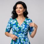 Woman wearing blue floral dress with V-neck neckline demonstrating flattering body shape matching and styling techniques