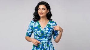 Woman wearing blue floral dress with V-neck neckline demonstrating flattering body shape matching and styling techniques