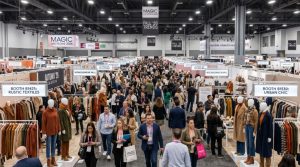 Crowded fashion trade show floor at MAGIC Las Vegas 2026 with exhibitor booths displaying autumn apparel and accessories collections