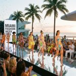 Models walking the runway at Miami Fashion Week 2026 with a crowd of fashion enthusiasts watching from the front row