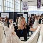Bride browsing wedding gowns at Colorado Bridal Show 2026