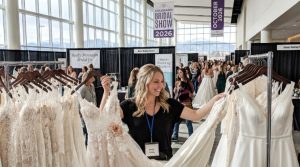 Bride browsing wedding gowns at Colorado Bridal Show 2026